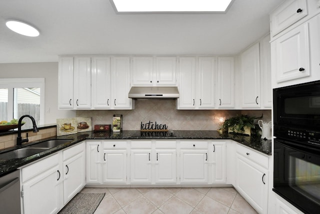 kitchen with dark stone counters, white cabinetry, under cabinet range hood, a sink, and black appliances