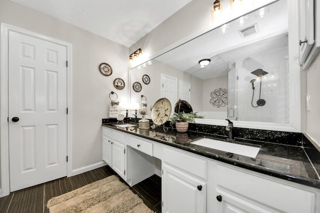 14110 Withersdale Dr, Houston, TX 77077 - full bath with double vanity, a shower stall, and wood finished floors