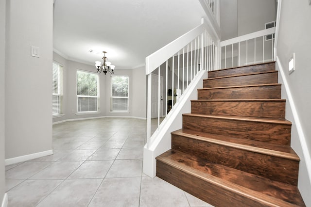 staircase featuring crown molding, tile patterned floors, baseboards, and a notable chandelier