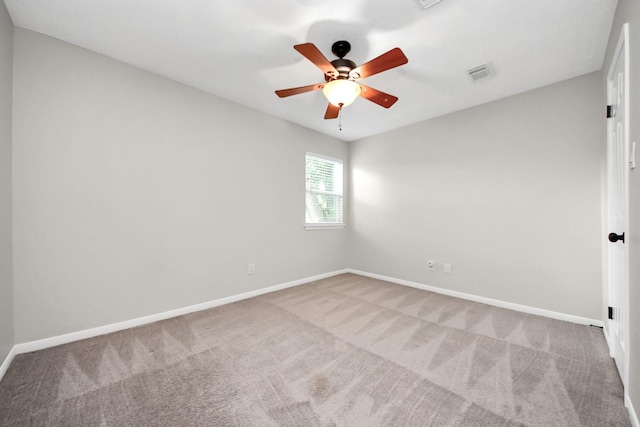 empty room with carpet floors, baseboards, and visible vents