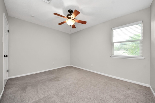 unfurnished room featuring carpet floors, a ceiling fan, and baseboards