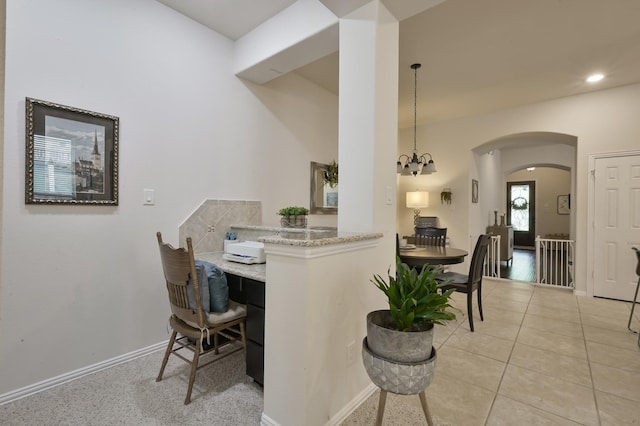 dining room featuring baseboards, arched walkways, recessed lighting, and light tile patterned floors