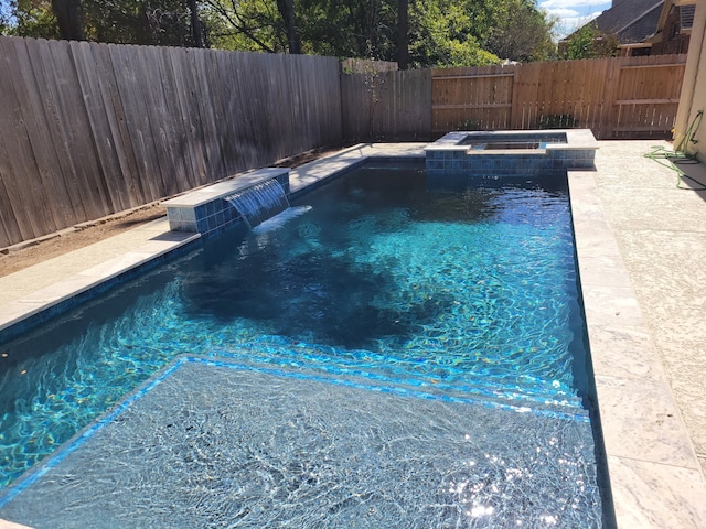 view of swimming pool with a pool with connected hot tub and a fenced backyard