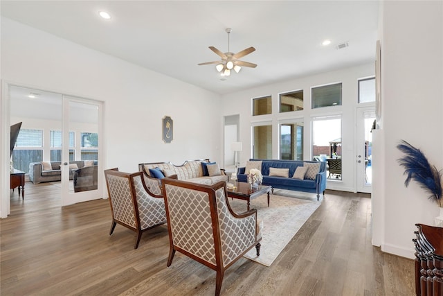 living room with a ceiling fan, wood finished floors, visible vents, and recessed lighting