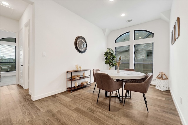 dining room featuring baseboards, wood finished floors, visible vents, and recessed lighting