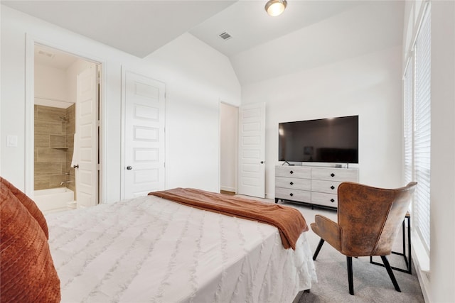 bedroom featuring vaulted ceiling, visible vents, connected bathroom, and carpet flooring