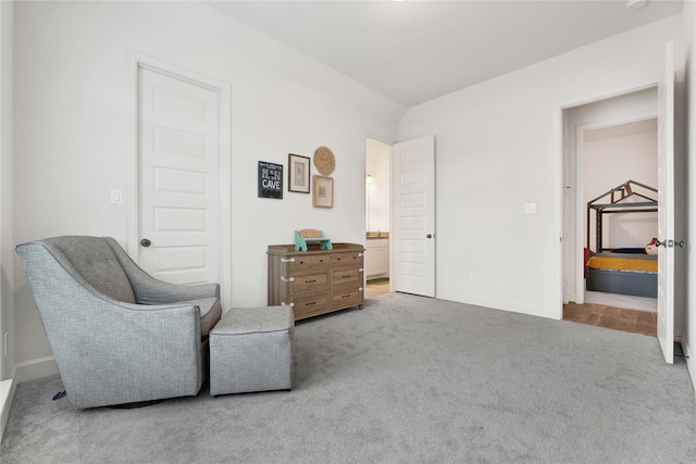 sitting room with baseboards and carpet