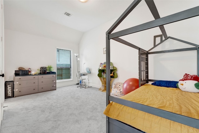 bedroom with vaulted ceiling, visible vents, and carpet flooring