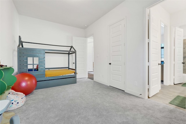 exercise room with carpet floors and baseboards