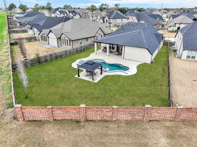view of pool with a fenced backyard, a yard, a patio, a fenced in pool, and a residential view