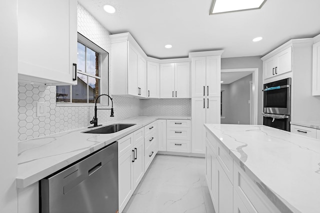 kitchen with appliances with stainless steel finishes, a sink, and recessed lighting