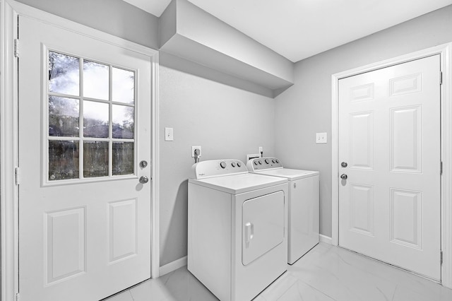 washroom with marble finish floor, washing machine and clothes dryer, baseboards, and laundry area