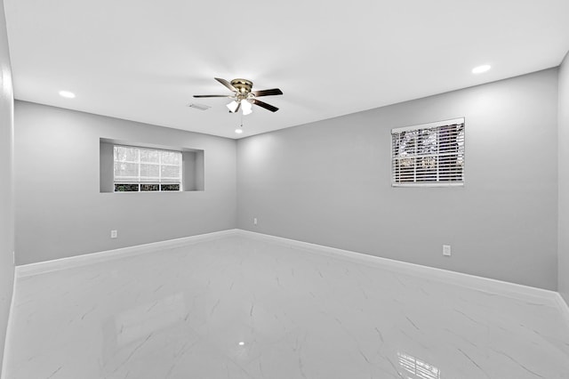 spare room with marble finish floor, ceiling fan, visible vents, and recessed lighting