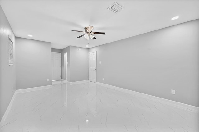 unfurnished room with visible vents, baseboards, recessed lighting, a ceiling fan, and marble finish floor