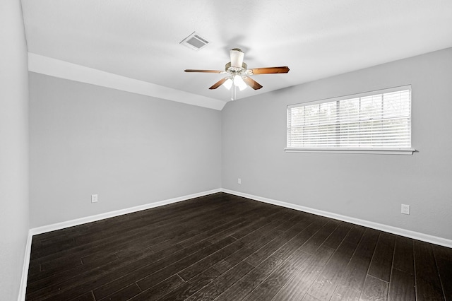 unfurnished room featuring dark wood finished floors, ceiling fan, baseboards, and visible vents