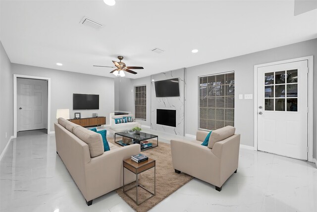 living room with marble finish floor, baseboards, visible vents, and recessed lighting