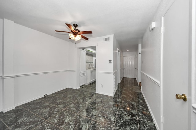 7954 Grove Ridge Dr, Houston, TX 77061 - spare room featuring baseboards, a ceiling fan, visible vents, and a sink