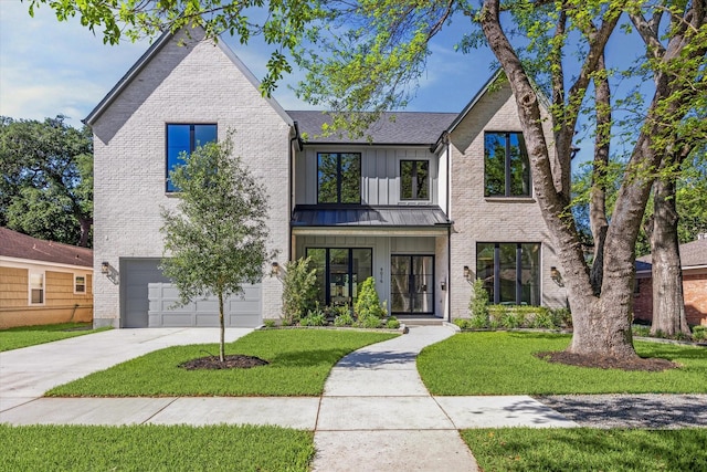 4016 Branard St, Houston, TX 77027 - view of front of home with an attached garage, a front lawn, driveway, and brick siding