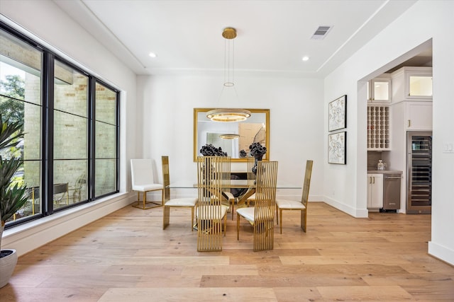 4016 Branard St, Houston, TX 77027 - dining area featuring light wood-type flooring, baseboards, visible vents, recessed lighting, and beverage cooler