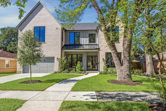 4016 Branard St, Houston, TX 77027 - view of front of property featuring concrete driveway, board and batten siding, brick siding, a front yard, and a garage