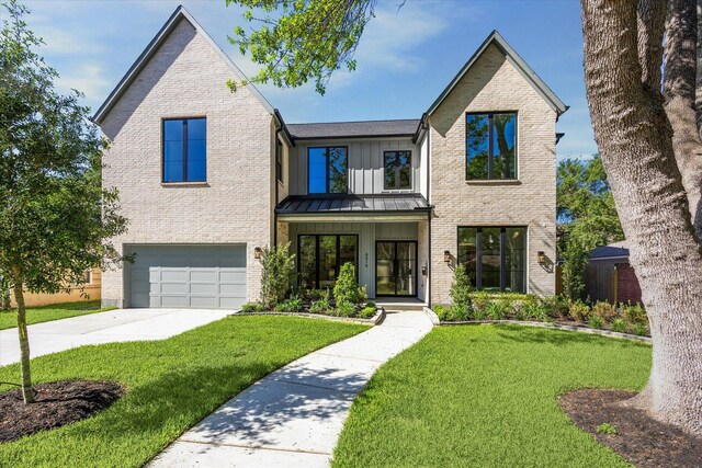 4016 Branard St, Houston, TX 77027 - view of front of property with an attached garage, a standing seam roof, a front lawn, and brick siding