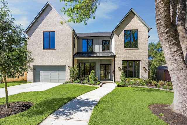 4016 Branard St, Houston, TX 77027 - view of front of home with a front yard, an attached garage, brick siding, driveway, and a standing seam roof