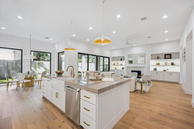 4016 Branard St, Houston, TX 77027 - kitchen featuring a ceiling fan, a sink, dishwasher, white cabinets, and visible vents