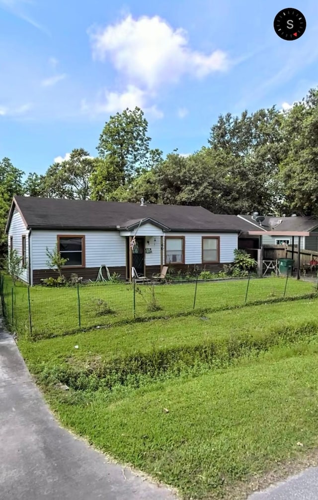 ranch-style home featuring fence private yard and a front lawn