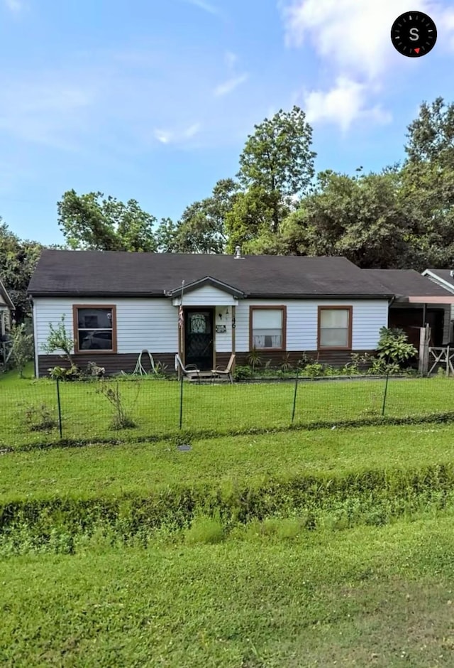view of front of property with fence private yard and a front lawn