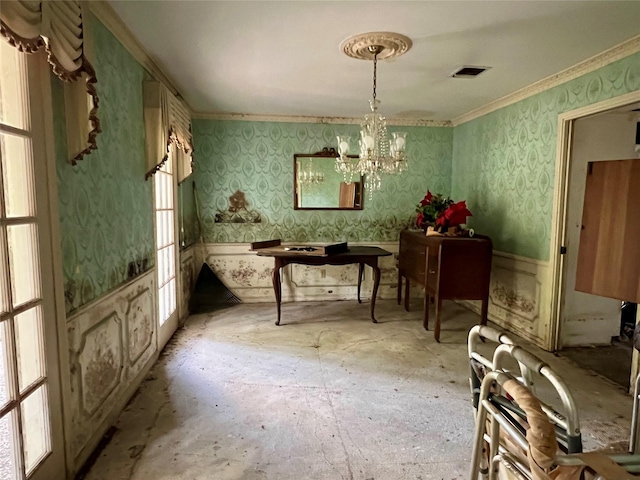 dining room with wallpapered walls, visible vents, a healthy amount of sunlight, crown molding, and a notable chandelier