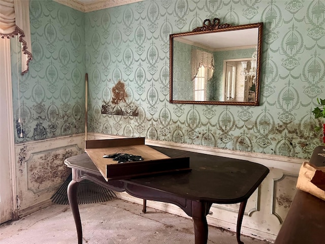 dining room featuring wallpapered walls and wainscoting