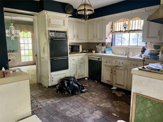 kitchen with an inviting chandelier, brick floor, dishwashing machine, and a healthy amount of sunlight