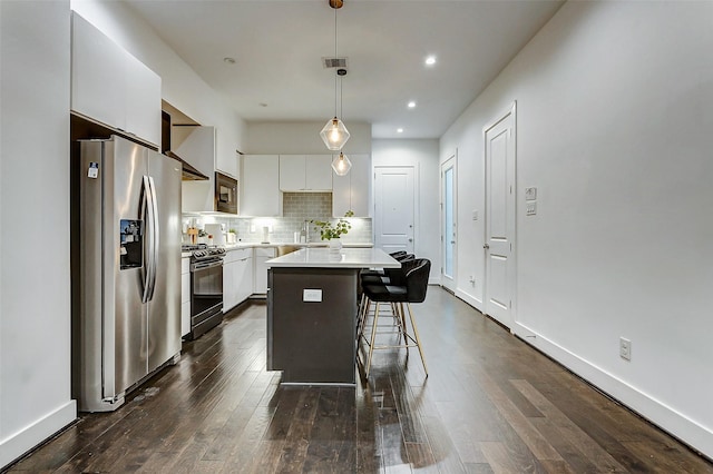 5841 Dolores St, Houston, TX 77057 - kitchen with stainless steel refrigerator with ice dispenser, gas stove, a center island, a kitchen breakfast bar, and white cabinetry