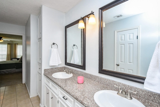 ensuite bathroom featuring visible vents, a sink, ensuite bath, and tile patterned floors