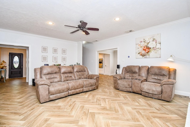 living area with crown molding, baseboards, visible vents, and ceiling fan