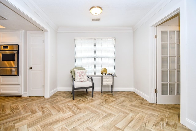 living area with baseboards, visible vents, and ornamental molding
