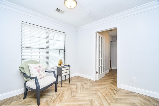 sitting room featuring crown molding, baseboards, and visible vents