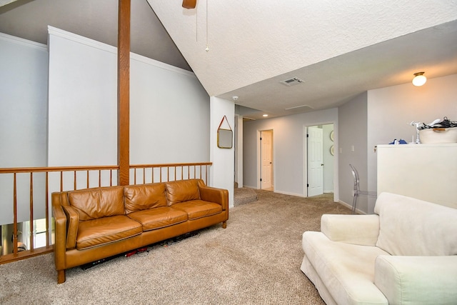 carpeted living room with a ceiling fan, visible vents, baseboards, lofted ceiling, and ornamental molding