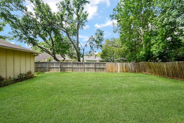 view of yard with a fenced backyard