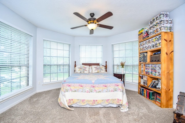 bedroom featuring carpet floors, baseboards, and ceiling fan