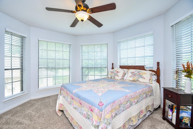 carpeted bedroom featuring baseboards and ceiling fan