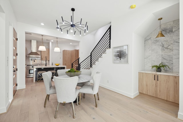 dining space with stairs, a chandelier, light wood-style flooring, baseboards, and recessed lighting