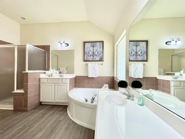 26936 Chateau Lake Dr, Kingwood, TX 77339 - full bathroom with a shower stall, wood finished floors, a sink, and tile walls