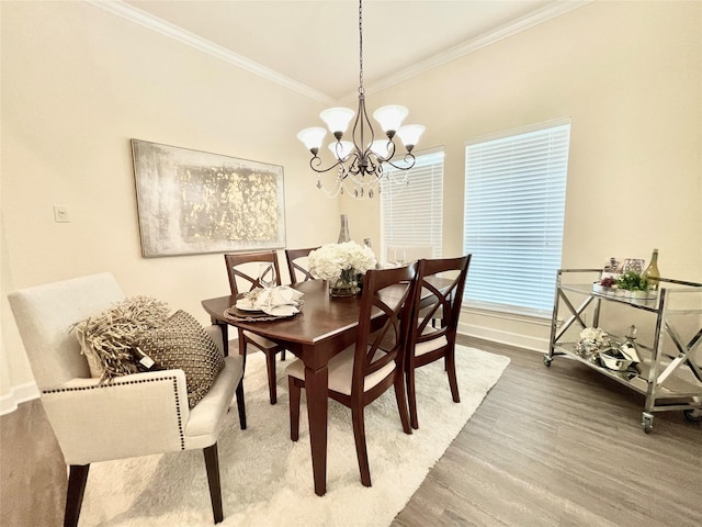 26936 Chateau Lake Dr, Kingwood, TX 77339 - dining space featuring baseboards, wood finished floors, a notable chandelier, and crown molding
