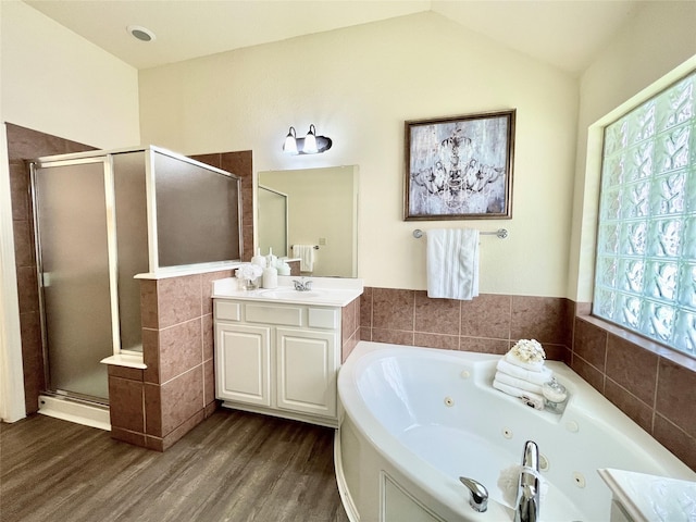 26936 Chateau Lake Dr, Kingwood, TX 77339 - full bathroom with a shower stall, a jetted tub, wood finished floors, and tile walls