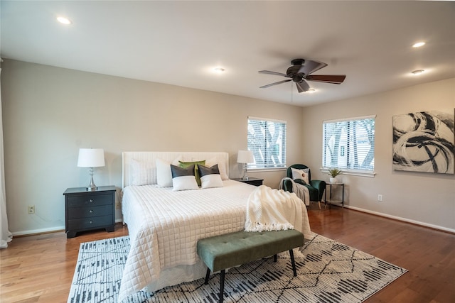 bedroom with recessed lighting, wood finished floors, baseboards, and ceiling fan
