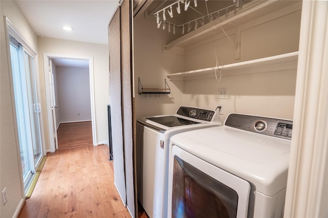laundry room with recessed lighting, laundry area, washing machine and dryer, light wood-type flooring, and baseboards
