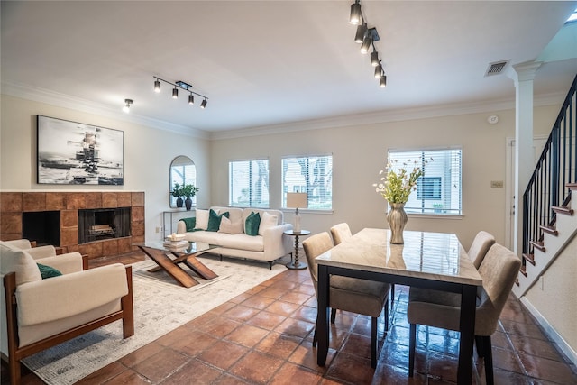 living room featuring plenty of natural light, track lighting, and visible vents