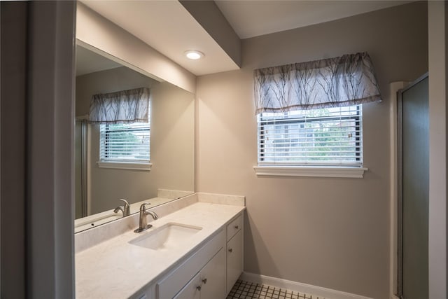 full bathroom featuring baseboards, tile patterned flooring, and vanity
