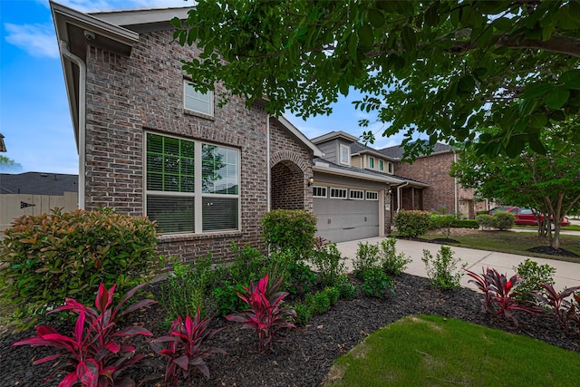 12205 Renewal Way, Houston, TX 77047 - traditional-style home featuring a garage, concrete driveway, and brick siding